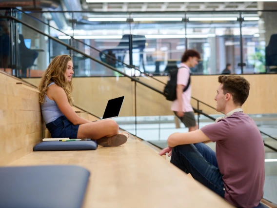 students sitting on staircase talking