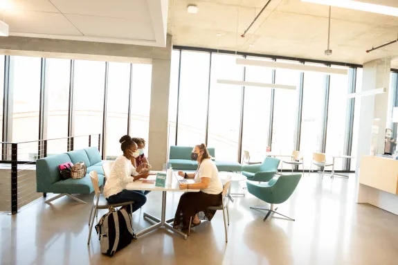 An Advisor and two students talking